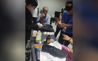 <p><strong>'FRAGRANT' DISCOVERY.</strong> Customs officers at the Ninoy Aquino International Airport (NAIA) examine the luggage owned by Turkish national Kemal Ozenir (center) who brought in PHP28.8 million worth of cocaine concealed in soap boxes on Tuesday (March 21, 2023). Authorities also confiscated from the suspect one Turkish passport, two boarding passes, one Turkish national ID card, and one State of Qatar residency permit ID card.<em> (Photo courtesy of BOC-NAIA)</em></p>