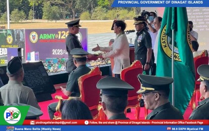 <p><strong>BEST RESERVE OFFICER.</strong> President Ferdinand R. Marcos Jr. (in barong) hands over the Best Reservist Officer of the Philippine Army Award to Dinagat Islands Governor Nilo Demerey Jr. during the celebration of the 126th Founding Anniversary of the Philippine Army in Fort Bonifacio, Taguig City on March 22, 2023. Demerey, who holds the rank of major in the Army Reserve Command, is the commander of the 1505th Ready Reserve Infantry Battalion based in Dinagat Islands. <em>(Photo courtesy of Dinagat Islands PIO)</em></p>