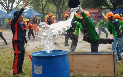 <p><strong>FIRE OLYMPICS</strong>. Volunteers from community fire auxiliary groups (CFAGs) compete in the 1st Mayor Albee Benitez Barangay Fire Olympics held at the Bacolod City Government Center football field on Friday (March 24, 2023). The Bureau of Fire Protection is pushing to form CFAGs as only eight out of the 61 villages in the city have organized their fire brigades. <em>(Photo courtesy of Bacolod City PIO)</em></p>