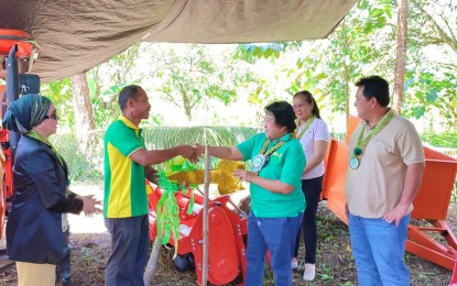 <p><strong>NEW FARM TRACTOR.</strong> Department of Agrarian Reform (DAR) Undersecretary Milagros Isabel Cristobal (in green, 3rd right) hands over Thursday (March 23, 2023) the symbolic key of a brand-new tractor to Upper Baguer Credit Cooperative chair Rutchil Omadle in Pigcawayan, North Cotabato, as local and DAR officials look on. The cooperative will utilize the PHP1.9-million farm tractor to till 80 hectares of land that its members own in the municipality. <em>(Photo courtesy of DAR-12)</em></p>