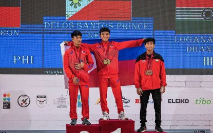 <p><strong>TOP THREE.</strong> Gold medalist Prince Keil Delos Santos (center) and silver medalist Eron Borres from the Philippines pose with bronze medalist Darush Loganathan of India (right) during the awarding ceremony of the men's 49kg category in the International Weightlifting Federation Youth World Championships at Ramazan Njala Sports Complex in Durres, Albania on Saturday (March 25, 2023). Delos Santos won two golds while Borres snatched the other gold to kick off the Philippines’ campaign.<em> (Courtesy of IWF)</em></p>