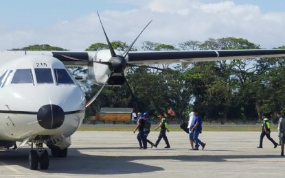 <p><strong>DUBIOUS.</strong> Three suspects arrested for alleged illegal possession of firearms and ammunition over the weekend board a military aircraft at Dumaguete-Sibulan Airport in Dumaguete City, Negros Oriental on Sunday afternoon (March 26, 2023). Raids were conducted on March 24 and 25 at a Sta. Catalina town sugar mill compound, where high-powered and short firearms, explosives, thousands of ammunition, and more than PHP 18 million in cash were found. <em>(Photo by Judy Flores Partlow)</em></p>
