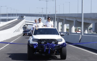 <p><strong>NLEX CONNECTOR</strong>. President Ferdinand R. Marcos Jr (right) leads the inauguration of the first section of the PHP23.2 billion North Luzon Expressway (NLEX) Connector from Caloocan to España on Monday (March 27, 2023). Public Works and Highways Secretary Manuel Bonoan and Metro Pacific Investments Corporation (MPIC) chairperson Manuel V. Pangilinan joined the President during the inaugural drive through on board a pick-up vehicle.<em> (PNA Photo by Alfred Frias)</em></p>