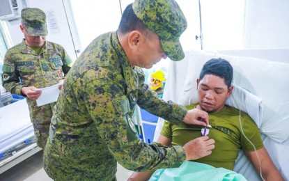 <p><strong>WOUNDED PERSONNEL.</strong> MEDAL Maj. Gen. Antonio Nafarrete, the Army’s 1st Infantry Division (ID) commander, pins a wounded personnel medal to a soldier for gallantry in action against New People's Army (NPA rebels in Maguing town, Lanao del Sur province, on March 25, 2023. An NPA rebel was killed while another was captured in another clash with government troops in Calamba, Misamis Occidental province on Sunday (March 26, 2023). <em>(Photo courtesy of 1ID)</em></p>