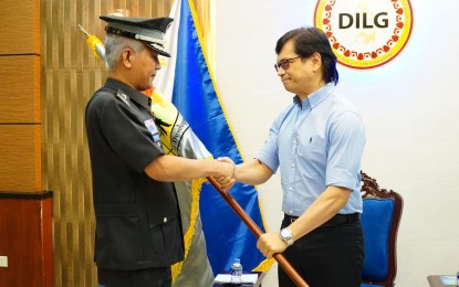 <p><strong>NEW BJMP CHIEF.</strong> Jail Chief Supt. Ruel Rivera receives the Bureau of Jail Management and Penology (BJMP) flag from Department of the Interior and Local Government (DILG) Secretary Benjamin Abalos Jr. when the former assumed as acting chief of the BJMP during a turnover ceremony in Camp Crame, Quezon City on March 27, 2023. President Ferdinand R. Marcos Jr. appointed Rivera as the 10th BJMP chief on June 26, 2023. <em>(Photo courtesy of BJMP)</em></p>