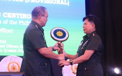 <p><strong>GENDER AND DEV’T.</strong> Armed Forces of the Philippines chief Gen. Andres Centino (left) turns over the symbol of the AFP Gender and Development Office to its first chief, Col. Arlene Frage, during simple rites in Camp Aguinaldo, Quezon City on Tuesday (March 28, 2023). Frage pledged to provide a safe space for both men and women that would cater to their development. <em>(Photo courtesy of AFP)</em></p>