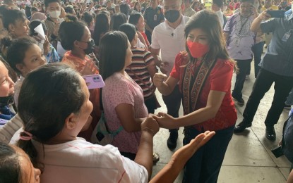 <p><strong>AICS DISTRIBUTION.</strong> Senator Imee Marcos receives a warm welcome as she leads the distribution of financial assistance to 1,365 beneficiaries of the Assistance to Individuals in Crisis Situation (AICS) program on Wednesday (March 29, 2023) at the provincial capitol compound in Agusan del Norte in Butuan City. Over PHP4 million in financial aid was released to the beneficiaries during the payout.<em> (PNA photo by Alexander Lopez)</em></p>