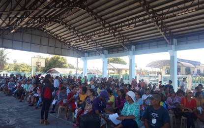 <p><strong>GOVERNMENT AID</strong>. Family members from over 5,000 households in Libmanan, Camarines Sur receive their salaries during a distribution activity in this undated photo. A total of PHP18.3 million was released by DSWD-Bicol to the beneficiaries of the cash-for-work program who rendered various community services.<em> (Photo courtesy of DSWD-Bicol)</em></p>