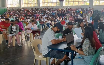 <p><strong>ASSISTANCE</strong>. Local residents seeking food and non-food assistance line up at a covered court in Bacarra, Ilocos Norte on March 28, 2023. Two more payout payouts were made Thursday and Friday (March 30 and 31). <em>(Courtesy of FAM Congressional District Office)</em></p>