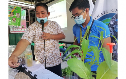 <p><strong>FOOD SECURITY</strong>. Agriculturist Ernie Bolloso (left) demonstrates to Camarin, Caloocan City residents the proper way of creating their own urban garden inside their homes during the Food Security Forum and Urban Agriculture on March 24, 2023. The office of Climate Change Commissioner Albert Dela Cruz Sr. conducted the forum in line with the Marcos administration’s advocacy of achieving food security and economic stability for all Filipinos. <em>(Photo courtesy of CCC)</em></p>