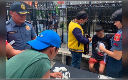 <p><strong>DRUG HAUL</strong>. Nineteen-year-old suspect (seated, second from right) is being profiled after his arrest inside a cemetery in Barangay Lorega, Cebu City, on Wednesday (March 29, 2023). He yielded PHP5.6 million worth of suspected shabu. <em>(Photo courtesy of Cebu City Police Office)</em></p>