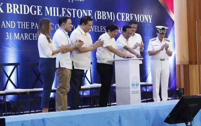 <p><strong>IMPROVING MOBILITY.</strong> President Ferdinand R. Marcos Jr. (center) graces the Bataan-Cavite Interlink Bridge milestone ceremony at the Maritime Academy of Asia and the Pacific in Mariveles, Bataan on Friday (March 31, 2023). Marcos noted that the BCIB is projected to reduce the Central Luzon - Calabarzon travel time from 5 hours to just 45 minutes. <em>(PNA photo by Alfred Frias)</em></p>