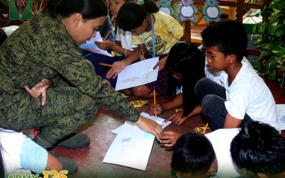 <p><strong>TRAUMATIZED.</strong> Undated photo shows a woman soldier facilitates a session with children affected by recent NPA attacks in Masbate. Psychosocial first aid has already been provided for them to cope with the trauma they experienced. <em>(Photo courtesy of 9ID)</em></p>