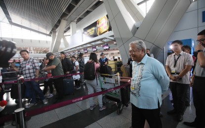<p><strong>ENSURING SMOOTH TRAVEL.</strong> Transportation Secretary Jaime Bautista (in light blue barong) checks on the situation at the Ninoy Aquino International Airport Terminal 2 on April 4, 2023. The Manila International Airport Authority on Wednesday (April 5, 2023) reported an orderly flow of passengers at the country's main gateway. <em>(PNA photo by Avito Dalan)</em></p>