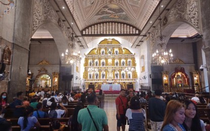 <p><strong>NO KISSING OF IMAGES</strong>. Churchgoers pray inside the Basilica Minore del Sto. Niño in Cebu City in this undated photo. The historical Basilica and over 170 parishes, mission stations, non-parochial, and national shrines in the Archdiocese of Cebu discourage the faithful from kissing relics and images of saints as precautionary measure against the coronavirus disease. <em>(PNA photo by John Rey Saavedra)</em></p>