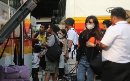 <p><strong>PEAK SEASON.</strong> Passengers queue up to board a provincial bus in Cubao, Quezon City on Holy Tuesday last year (April 4, 2023). All health and security agencies are on high alert every Lenten season due to the high volume of travelers.<em> (PNA file photo by Joan Bondoc)</em></p>