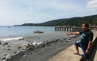 <p><strong>CATANDUANES COAST.</strong> Gigmoto Mayor Vicente Tayam Jr. on the coast of the town in Catanduanes on April 5, 2023. The Philippine Coast Guard on Tuesday (May 7, 2024) said a base in Catanduanes is being eyed to help boost the country's response to territorial incursions and other maritime-related incidents in the country's eastern seaboard. <em>(PNA photo by Connie Calipay)</em></p>