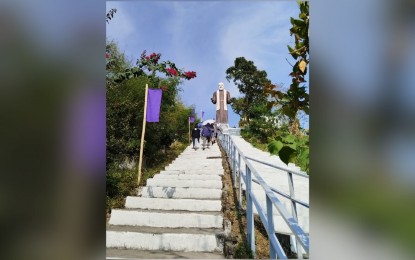<p><strong>PILGRIMAGE.</strong> Catholic devotees climb the 150 steps to visit the 50-foot statue of St. Padre Pio at the Padre Pio Mountain of Healing located at Barangay Paradise 3, in San Jose Del Monte City, Bulacan province. The place is now considered a pilgrimage site where devotees attend mass and pray for healing. <em>(PNA photo by Raquel Bonustro)</em></p>