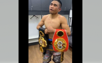 <p><strong>CHAMP AGAIN</strong>. Filipino Marlon Tapales shows his WBA-IBF super bantamweight titles after stunning Murodjon Akhmadaliev of Uzbekistan in their unified 122-pound bout at Boeing Center in San Antonio, Texas on Sunday, Philippine time (April 9, 2023). The Filipino won in two of the three judges’ scorecards to deal Akhmadaliev his first loss after 11 victories.<em> (Screengrab Tapales’ Facebook video)</em></p>