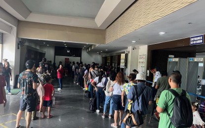 <p><strong>PASSENGERS</strong>. Travelers bound for Iloilo City queue at the Bredco port in Bacolod City on Monday afternoon (April 10, 2023). Authorities expect huge volume of passengers, which is the last day of the five-day Holy Week break. <em>(Photo courtesy of Coast Guard District-Western Visayas) </em></p>