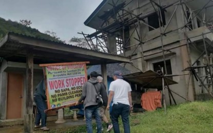 <p><strong>ILLEGAL STRUCTUR</strong>E. Personnel of the Community Environment and Natural Resources Office in Cadiz City install a notice of violation on an illegal construction inside the Northern Negros Natural Park in Negros Occidental province in a photo released by the Department of Environment and Natural Resources on Wednesday (April 12, 2023). The construction lacks all the permits required to build such a structure in the multiple-use zone. <em>(Photo courtesy of DENR-Western Visayas)</em></p>