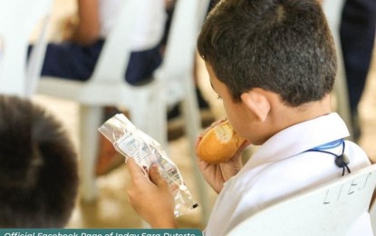 <p><strong>SUPPLEMENTAL NUTRITION.</strong> A student from Lower Tamugan Elementary School in Davao City enjoys his 'Pansarap' bun after the Office of the Vice President pilot-tested the program in the school on Tuesday (April 11, 2023). The Pansarap is a supplemental nutrition intervention for undernourished learners.<em> (Photo from Inday Sara Duterte Facebook Page)</em></p>