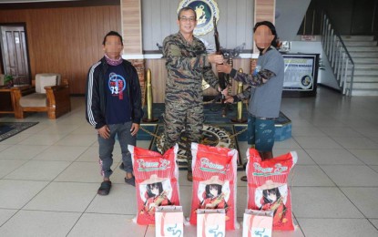 <p><strong>ASG SURRENDERERS.</strong> Two Abu Sayyaf extremists surrendered to authorities Tuesday (April 11, 2023) amid continuing military operations against them in Basilan province. They were presented to Rear Admiral Donn Anthony Miraflor, Naval Forces Western Mindanao commander (center), and were given initial assistance.<em> (Photo courtesy of NFWM)</em></p>