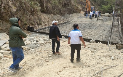 <p><strong>REHABILITATION PROJECT.</strong> Officials from the Department of Public Works and Highways-Nueva Ecija 2nd District Engineering Office inspect the ongoing repair of the Calaanan section of the Nueva Ecija-Aurora Road in Bongabon town, Nueva Ecija province in this undated photo. It is one of the two rehabilitation projects along the road being fast-tracked to ensure the safety and convenience of travelers.<em> (Photo courtesy of the DPWH Region III)</em></p>