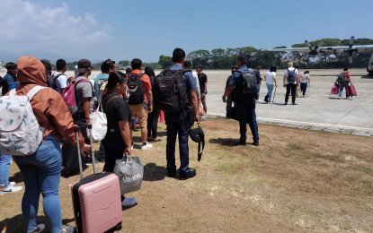 <p><strong>DESPERATELY SEEKING JUSTICE.</strong> Families of slay victims and witnesses to killings in Negros Oriental board a Manila-bound C-130 Air Force aircraft at Dumaguete-Sibulan Airport in Dumaguete City on Saturday morning (April 15, 2023). They attended Monday’s preliminary investigation by the Department of Justice on the murder of Governor Roel Degamo and eight others and the start of a Senate probe. <em>(PNA photo by Judy Flores Partlow)</em></p>