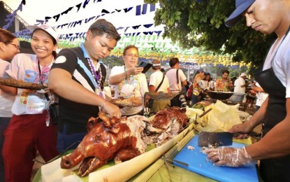 <p><strong>‘SUROY-SUROY SUGBO’.</strong> Tourists enjoy Cebu's roasted pig (lechon) during the Suroy-Suroy Sugbo over the weekend (April 15 and 16, 2023) in the Camotes group of islands. Department of Tourism Secretary Christina Garcia-Frasco and Senator Robin Padilla joined the Cebu provincial government-organized guided tour as a way to promote culture and heritage in the countryside.<em> (Photo courtesy of Cebu Capitol PIO)</em></p>
