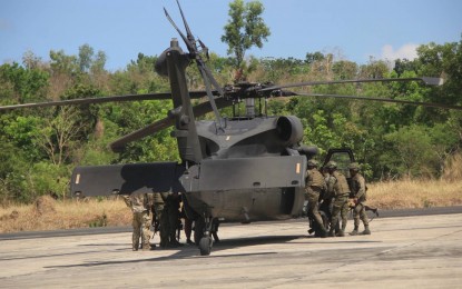 <p><strong>HELIBORNE OPS</strong>. Army soldiers board the "Black Hawk" combat utility helicopter on April 19, 2023 to participate in the air assault exercise in Zambales. Air Force spokesperson Col. Ma. Consuelo Castillo on Thursday (April 20) said the S-70is are from the 205th Tactical Helicopter Wing and played a "critical role" in the drills. <em>(Photo from PAF) </em></p>