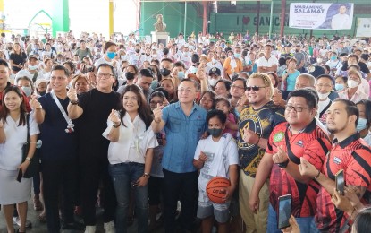 <p><strong>FINANCIAL AID</strong>. Senator Christopher Lawrence Go (middle) and other officials pose with the 1,000 beneficiaries of the Assistance to Individuals in Crisis Situations (AICS) of the Department of Social Welfare and Development (DSWD) in San Carlos City, Pangasinan on Monday (April 24, 2023). The beneficiaries received PHP3,000 each from the DSWD and grocery items from Go's office. <em>(Photo by Hilda Austria)</em></p>