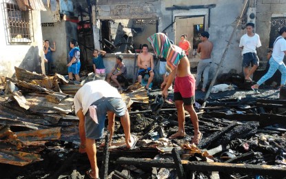 <p><strong>IN RUINS.</strong> Fire victims in Punta Dumalag 1, Barangay Matina Aplaya, Davao City, salvage whatever remains of their gutted houses on Tuesday (April 25, 2023). The April 21 fire gutted some 40 houses, affecting more than 60 families. <em>(PNA photo by Robinson Niñal Jr.)</em></p>