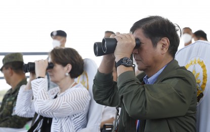 <p><strong>LIVE-FIRE DRILLS.</strong> President Ferdinand R. Marcos Jr. uses binoculars as he witnessed the live-fire sea drills of the Philippines and the United States to culminate the field training event for this year's Balikatan Exercise in San Antonio, Zambales on Wednesday (April 26, 2023). The 2023 Balikatan Exercise kicked off last April 11 with over 17,600 participating Filipino and American military personnel. <em>(PNA photo by Alfred Frias)</em></p>