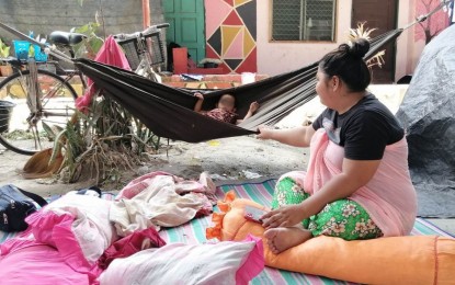 <p><strong>EVACUEES.</strong> A mother and her child temporary seek shelter in one of the evacuation centers in Datu Saudi Ampatuan town, Maguindanao del Sur province after being displaced by intermittent clashes between Moro Islamic Liberation Front groups in the area due to 'rido or family feud. More than 17,000 civilians are estimated to have been affected by the conflict. <em>(Photo courtesy of PDRRMO-Maguindanao del Sur)</em></p>