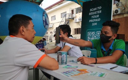 <p><strong>SIM REGISTRATION.</strong> A resident in Malita, Davao Occidental, is being assisted by a telco personnel during the remote SIM card registration initiated by the National Telecommunications Commission in Davao Region (NTC-11) in the town last month. From January to April 25, NTC-11 logged more than 20,000 individuals who received assistance and successfully registered their SIM cards.<em> (PNA photo by Robinson Niñal Jr.)</em></p>