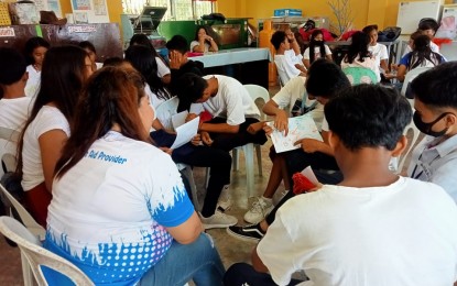 <p><strong>ADDRESSING TRAUMA</strong>. Undated photo shows a Department of Education personnel facilitating a psychological first aid session for students affected by recent New People's Army attacks in Masbate province. The intervention was provided to help the learners cope with the trauma they experienced. <em>(Photo courtesy of DepEd-Bicol)</em></p>