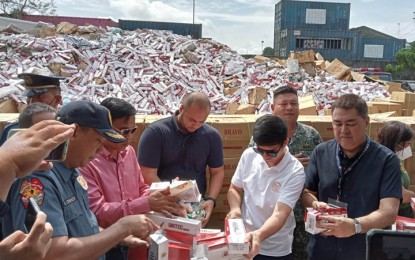 <p><strong>CEREMONIAL DESTRUCTION.</strong> Mayor John Dalipe (2nd right) and Bureau of Customs-Port of Zamboanga acting district collector, Engr. Arthur Sevilla (right), lead the ceremonial destruction of confiscated smuggled cigarettes in Zamboanga City on Friday (April 28, 2023). Sevilla said the 19,419 masters cases and 667 reams of smuggled cigarettes that were seized during a series of anti-smuggling operations in the Zamboanga Peninsula, Basilan, Sulu, and Tawi-Tawi in the first quarter of 2023. <em>(PNA photo by Teofilo P. Garcia Jr.)</em></p>