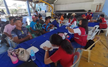 <p><strong>PAYOUT.</strong> A total of 190 farmers of Barangay Napacao, Siaton, Negros Oriental receive PHP3,000 each from the Department of Social Welfare and Development - Assistance to Individuals in Crisis Situations program on Friday (April 28, 2023). They are members of Paglaum sa Mag-uuma sa Negros Oriental, which is locked in a land dispute with a private individual. <em>(PNA photo by Judy Flores Partlow)</em></p>