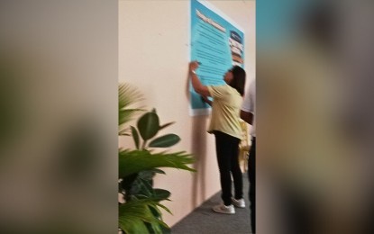 <p><strong>PROTECTION</strong>. Liga ng mga Barangay Antique president Pamela Socorro-Azucena signs the pledge of commitment and support for the "Chikiting Ligtas" program or the supplemental immunization for measles and rubella and oral polio vaccine on Friday (April 28, 2023). She and barangay officials commit their full support to the campaign during the entire month of May.<em> (PNA photo by Annabel Consuelo J. Petinglay)</em></p>