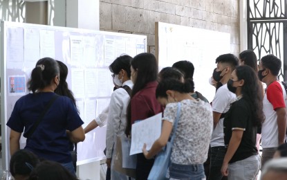 <p><strong>EMPLOYABLE.</strong> Job seekers go over the list of vacancies at the Marikina City job fair on Labor Day Monday (May 1, 2023). Those who tried their luck included fresh graduates, returning overseas Filipino workers and displaced employees during the Covid-19 pandemic, some of whom were hired on the spot. (<em>PNA photo by Joey O. Razon)</em></p>