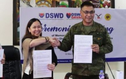 <p><strong>PARTNERSHIP.</strong> Department of Social Welfare and Development in Davao Region Director Vanessa Goc-ong (left) and Maj. Gen. Jose Eriel Niembra, Army’s 10th Infantry Division commander, sign a memorandum of understanding on providing immediate support to disaster-affected areas. The agreement, signed on Tuesday (May 2, 2023) in Davao City, aims to fast-track the pre-positioning of relief items at a storage facility of the 10ID in Mawab, Davao De Oro province. <em>(Photo courtesy of 10ID)</em></p>