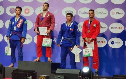 <p><strong>BRONZE MEDALIST.</strong> Fierre Proudhon Afan (third from left) and other winners in the qualifying round pose for a photo in Tashkent. Afan will be seeing action in the World Combat Games after clinching bronze in the qualifiers. <em>(Contributed photo)</em></p>