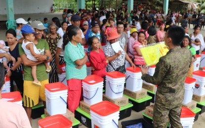 <p><strong>ASSISTANCE</strong>. Residents of Barangay Paitan in Escalante City, Negros Occidental affected by a recent encounter between New People’s Army rebels and government troops receive survival kits from the Department of Social Welfare and Development on Tuesday (May 2, 2023). The distribution of assistance was facilitated by the Philippine Army’s 79th Infantry Battalion. <em>(Photo courtesy of 79th Infantry Battalion, Philippine Army)</em></p>