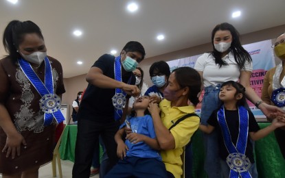 <p><strong>CHIKITING LIGTAS</strong>. Pangasinan Gov. Ramon Guico III (second from left) administers an oral polio vaccine to a child during the launching of the Chikiting Ligtas vaccination campaign program on May 3, 2023. The Department of Health offers mobilization funds and incentives to local government to ramp up their vaccination campaign. <em>(Photo courtesy of Pangasinan Provincial Information Office)</em></p>