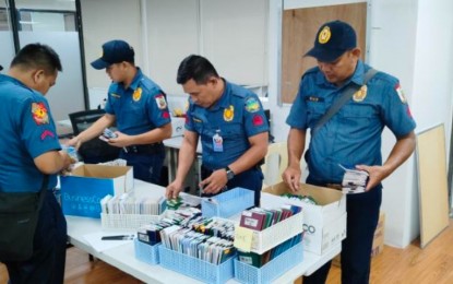 <p><strong>EVIDENCE.</strong> Police operatives check on the pieces of evidence they found when they rescued over 1,000 alleged victims of human trafficking, including foreigners, who are allegedly being forced to work for a fraudulent cyber-enabled industry during an operation in Mabalacat City, Pampanga on May 4, 2023. Senator Sherwin Gatchalian recently filed Senate Resolution No. 611 directing the appropriate committee to conduct an inquiry, in aid of legislation, to look into the alleged human trafficking happening inside the Clark Free Port Zone in particular. <em>(Photo courtesy of PNP) </em></p>