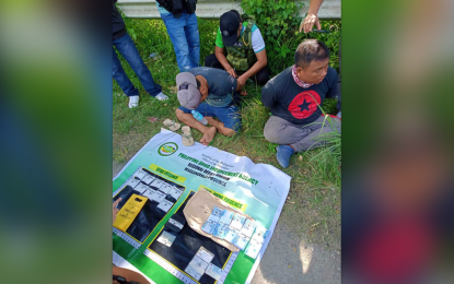 <p><strong>BUSTED</strong>. PDEA personnel secure the two drug suspects while the other agents conduct an accounting of the drugs seized from them during a buy-bust operation in Cotabato City Thursday (May 4, 2023). An estimated PHP3.4 million worth of shabu are seized from the suspects. <em>(Photo courtesy of PDEA-BARMM)</em></p>