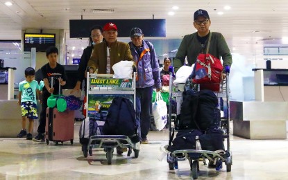 <p><strong>HOME.</strong> A total of 74 repatriates from war-torn Sudan, consisting of 45 overseas Filipino workers, 22 children, and seven students, arrive at the Ninoy Aquino International Airport Terminal 1 in Parañaque City on Thursday (May 4, 2023). The Department of Migrant Workers said it will explore employment possibilities for the repatriates if they decide to stay home for good. <em>(PNA photo by Yancy Lim)</em></p>