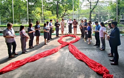 <p><strong>HIV AWARENESS. </strong>The HIV awareness program starts with a candlelight ceremony in front of the Philippine Information Agency building on Visayas Avenue in Quezon City on Monday (May 8, 2023). The ceremony commemorates the hardships faced by PLHIVs and the people who have died from HIV.<em> (PNA photo by Teresa Montemayor)</em></p>
