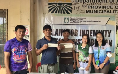 <p style="text-align: left;"><strong>INDEMNIFIED. </strong>Two corn farmers in Carmen, North Cotabato show the checks they received from the Philippine Crop Insurance Corporation and Department of Agrarian Reform on Saturday (May 6, 2023). A total of 227 agrarian reform beneficiaries, whose crops were damaged by calamities in the previous cropping season, received indemnification. <em>(Photo courtesy of DAR-North Cotabato) </em></p>